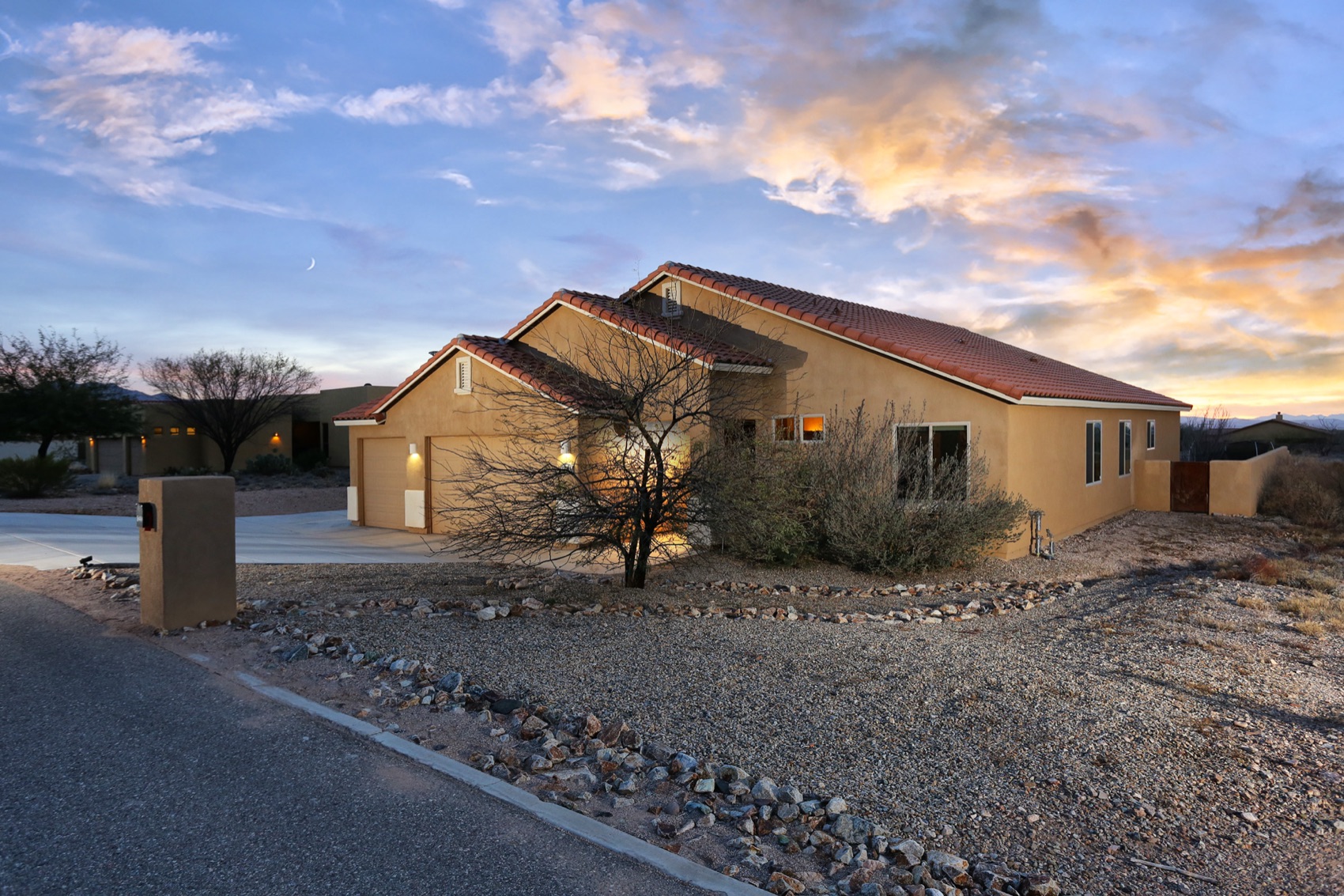 A Tucson ranch property under a dramatic sunset sky